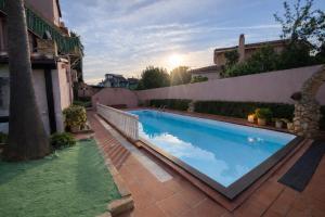 a swimming pool in the backyard of a house at Vincent house in Quartu SantʼElena
