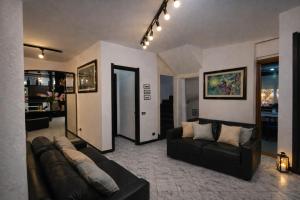 a living room with two couches and a couch at Vincent house in Quartu SantʼElena