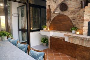 a patio with a table and chairs and a brick wall at Vincent house in Quartu SantʼElena