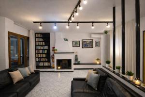 a living room with a couch and a fireplace at Vincent house in Quartu SantʼElena +26 photos