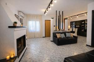 a living room with a couch and a fireplace at Vincent house in Quartu SantʼElena