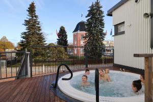 a group of people in a hot tub on a deck at SpaHotel Hamina in Hamina