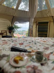 a bed with a plate of food on it at Gränna Glamping in Gränna +51 photos