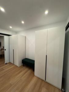 a room with white walls and a green bench in it at Black Forest Vista - Pool Sauna Tennis in Schonach +43 photos