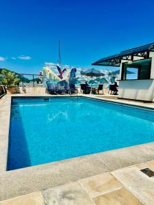 a large swimming pool with an airplane in the background at Copacabana Mar Hotel in Rio de Janeiro