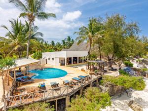 an aerial view of a resort with a pool and deck at Tanzanite Beach Resort and Spa in Nungwi