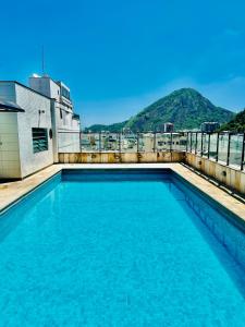 a swimming pool on the roof of a building at Copacabana Mar Hotel in Rio de Janeiro