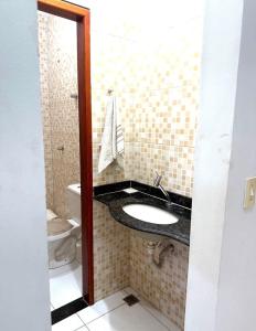 a bathroom with a sink and a toilet at Cond Cristo Redentor in Trindade +10 photos