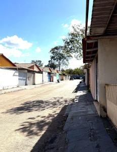 an empty street in a small town with a building at Cond Cristo Redentor in Trindade