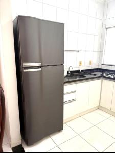 a stainless steel refrigerator in a kitchen at Cond Cristo Redentor in Trindade