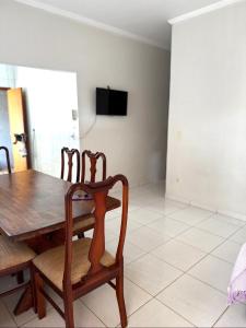 a dining room with a wooden table and chairs at Cond Cristo Redentor in Trindade