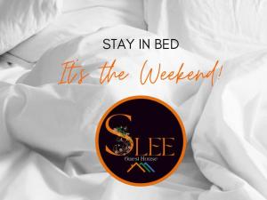 a sign that says stay in bed its the weekend at Slee Guest House in Howick