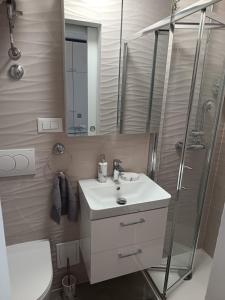 a bathroom with a sink and a shower at Omiš centar studio apartment in Omiš +3 photos
