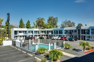 a parking lot in front of a building at Hotel Seville - Ontario Airport/Chino in Ontario