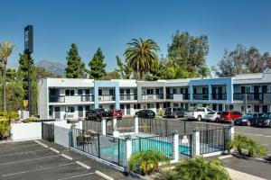 a parking lot in front of a building at Hotel Seville - Ontario Airport/Chino in Ontario