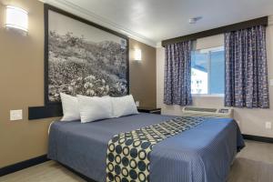 a hotel room with a bed and a window at Hotel Seville - Ontario Airport/Chino in Ontario +45 photos