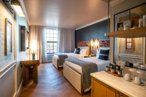 a hotel room with two beds and a table at Delamar Westport in Westport +66 photos