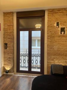 a large glass door with a balcony in a room at Total Valencia Elegance in Valencia