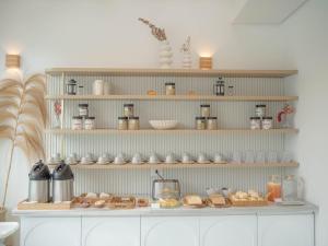 a shelf with food and other items on it at Olisa Praia Hotel in Maresias