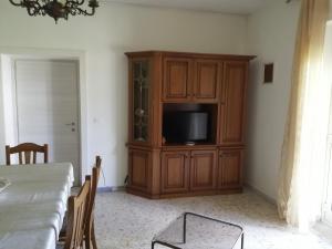 a living room with a tv and a entertainment center at Casa di Biagio e Maria in Trecchina