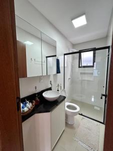 a bathroom with a sink and a toilet at Apê Ásia in Governador Celso Ramos +8 photos