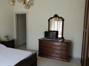 a bedroom with a dresser with a mirror and a bed at Casa di Biagio e Maria in Trecchina +62 photos