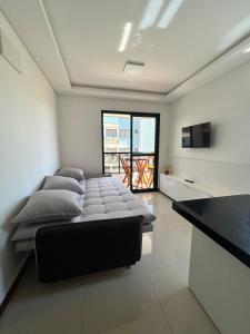 a large white room with a bed and a television at Apê Ásia in Governador Celso Ramos