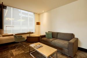 a living room with a couch and a table at EK Hotel By Preferred Hotels Group in Bogotá