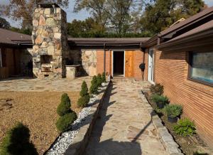 a house with a stone walkway next to a building at oak&stone in Dalton