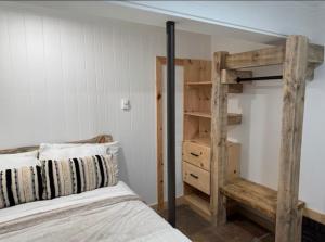 a bedroom with a bunk bed and a book shelf at oak&stone in Dalton