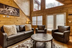 a living room with a couch and two chairs and a table at Ole Red in Gatlinburg