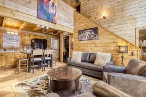 a living room with a couch and a table at Ole Red in Gatlinburg +33 photos