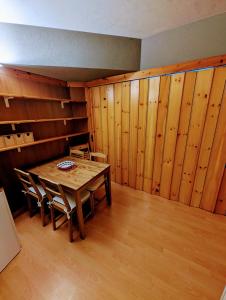 a dining room with a table and wooden walls at "FamilyNest" by Staymarilleva1400 in Marilleva