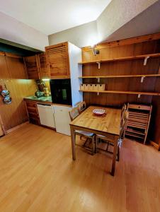 a dining room with a table and a kitchen at "FamilyNest" by Staymarilleva1400 in Marilleva