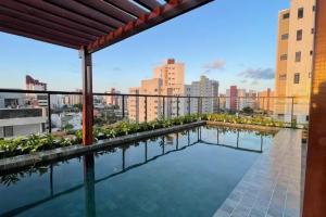 a swimming pool on the roof of a building at FLAT Intermares HUB 105 in Cabedelo