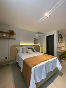 a bedroom with a large bed and a table at FLAT Intermares HUB 105 in Cabedelo +8 photos