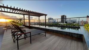 a balcony with a bench and water on a building at FLAT Intermares HUB 105 in Cabedelo