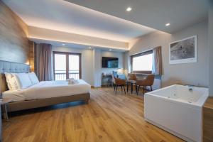 a hotel room with a bed and a bath tub at Lift Hotel in Sauze dʼOulx