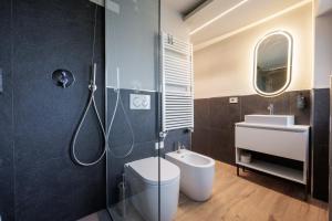 a bathroom with a shower and a toilet and a sink at Lift Hotel in Sauze dʼOulx