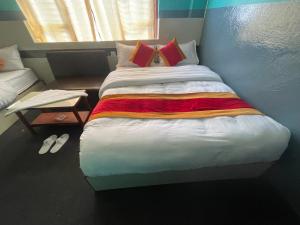 a bedroom with a large bed with red pillows at Parbat unique guest house in Kathmandu