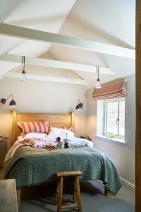 a bedroom with a large bed and a window at Courtyard Cottages Lymington, 2 Adults only in Lymington