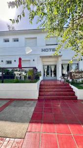 a hotel with a red carpet in front of it at Hotel Maresias in Villa Gesell