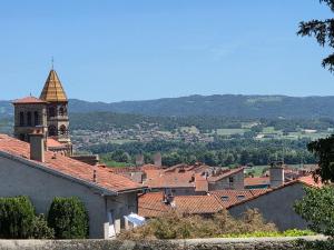 a view of a town with a church and roofs at Le Sebastopol- Studio cosy en centre ville de Brioude in Brioude