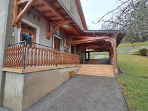 a porch of a house with a wooden deck at Gîte "EN VALROMEY" au pied du Grand Colombier in Munet