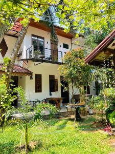 a house with a garden in front of it at Pearl Bungalow Trincomalee in Trincomalee