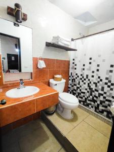 a bathroom with a sink and a toilet and a mirror at Hotel Kali Huasteca in Ciudad Valles +48 photos