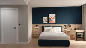 a bedroom with a bed and a blue wall at Spark By Hilton Van City Centre in Van