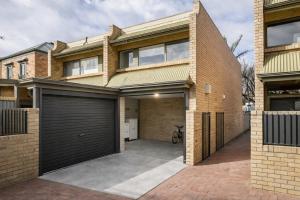 a brick house with a garage at Modern 2BR Apartment North Adelaide in North Adelaide