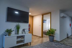 a living room with a flat screen tv on a wall at Casa da Eira Campia in Vouzela