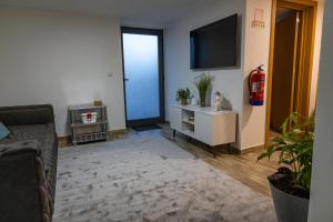 a living room with a couch and a flat screen tv at Casa da Eira Campia in Vouzela +2 photos